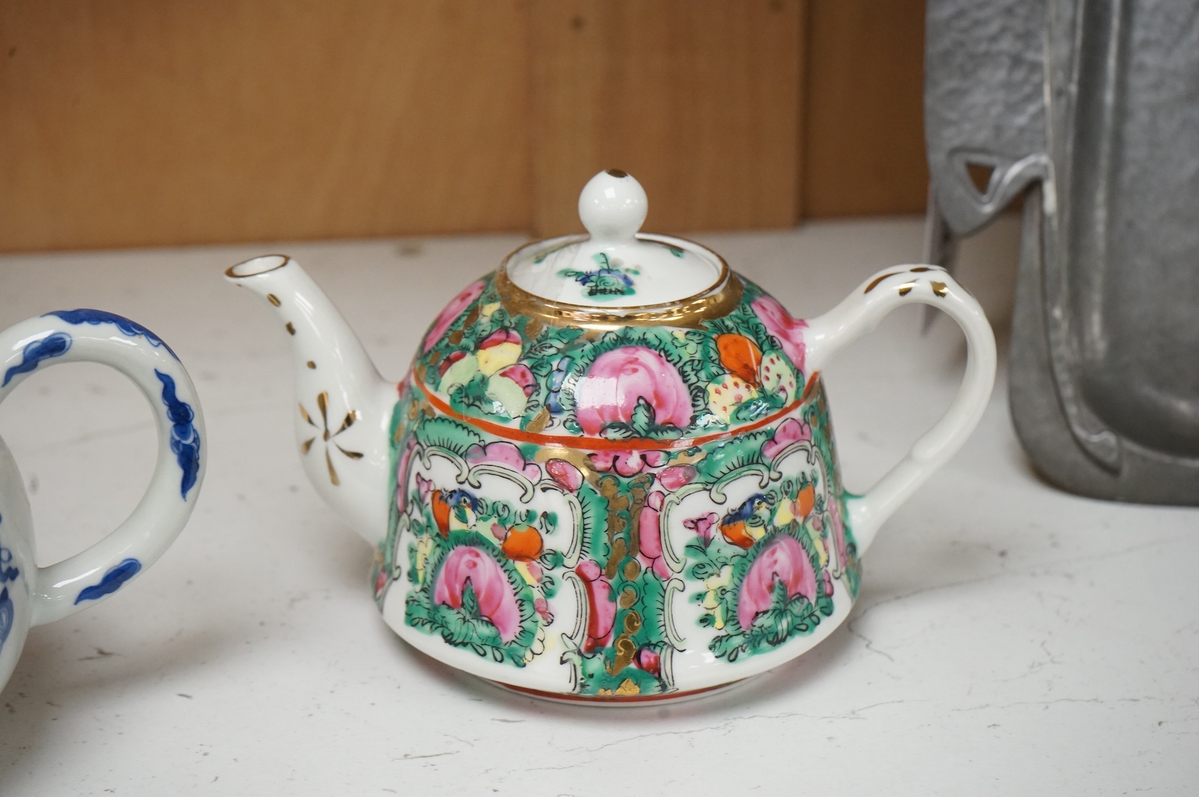 Two Chinese teapots comprising a blue and white and famille rose example, largest 16cm wide